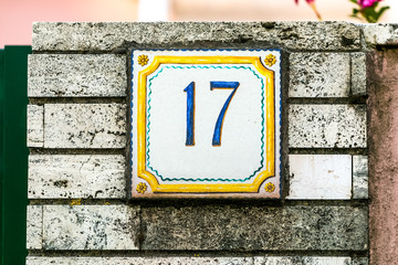 Brick wall with plate number seventeen