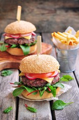Homemade beef burger with vegetables and french fries.