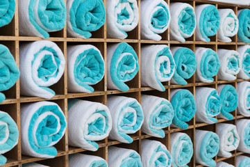 close up of shelf with rolled bath towels