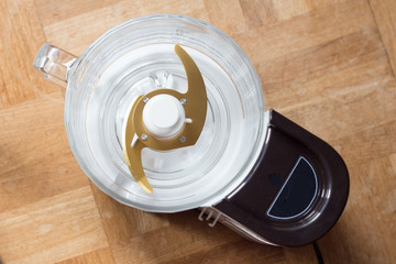 Food processor with gold blades taken from overhead perspective