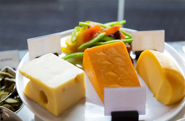 close up of cheese on showcase at cafe