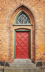 Red door in brick wall