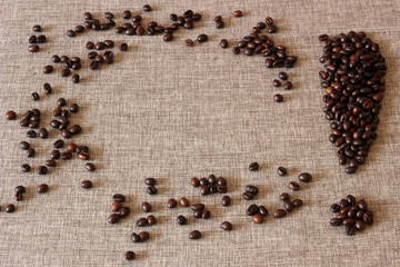 Frame made of coffee beans with an exclamation mark on sack cloth background.