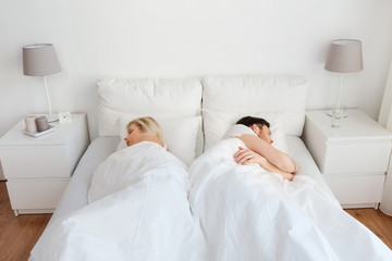 Fototapeta na wymiar couple sleeping in bed at home