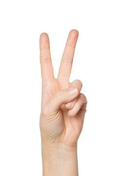 close up of hand showing peace or victory sign