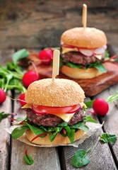 Homemade beef burger with vegetables and french fries.