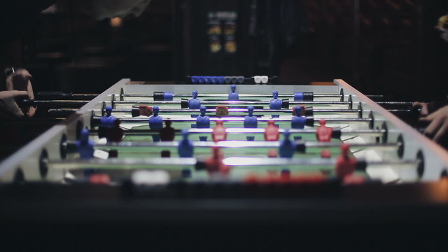 Friends having fun together playing table football