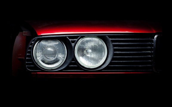 Headlights of the old red car close-up photo