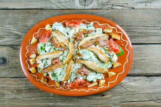 Caesar salad on a clay plate
