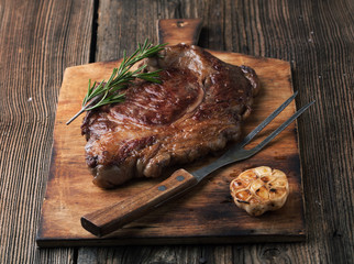 Grilled ribeye steak marbled meat with  rosemary and garlic