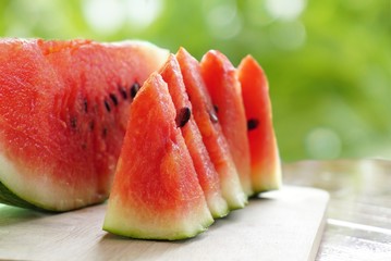 fresh watermelon fruit sliced on green nature bokeh background