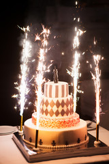 Festive wedding cake with fireworks on a dark background