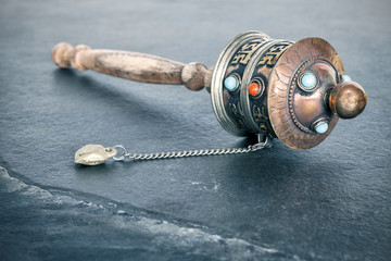 Vintage toned old Tibetan prayer wheel used to accumulate wisdom and good karma and to purify bad...