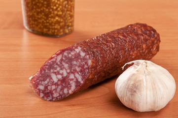 Salami for Breakfast with pepper on a wooden table