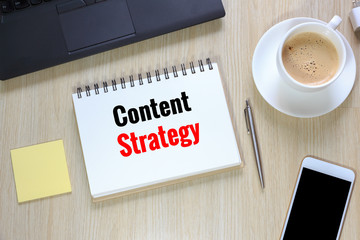 Top view of Content Strategy on office desk  with computer and smartphone