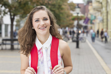 happy   girl with school bag on  street