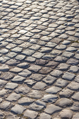 Background image of old cobblestone road backlit.