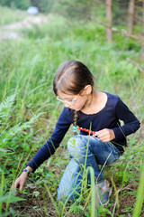 Harvests of berries. Kid girl pick up berries