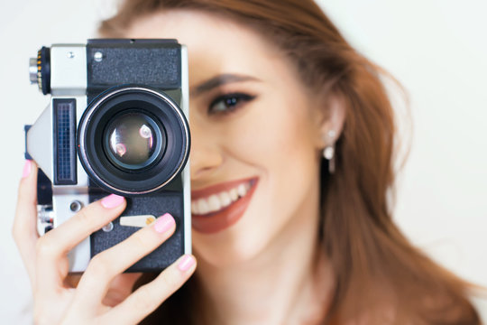 cute girl make a foto selfie at vintage camera.