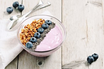 Blueberry yogurt bowl with homemade granola,fresh blueberry and chia seeds. Healthy eating. Superfoods concept