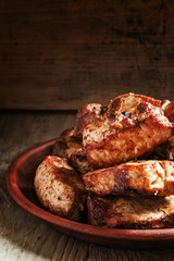 Grilled meats, hot pieces on a clay dish, selective focus
