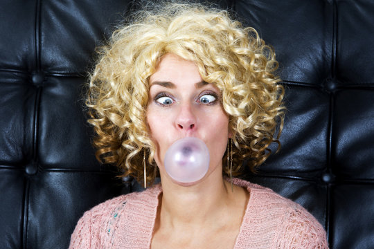 Portrait Of Cross-eyed Blond Woman With Bubblegum