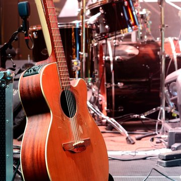 Guitar and other musical equipment on stage before concert