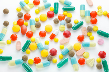 Colorful many tablets ,pills and pill capsules on white backgrou