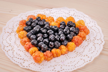 Cloudberry on wooden background 
