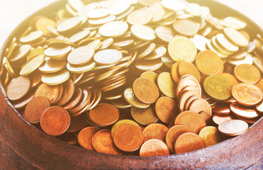 Selective focused coins in old monk's alms-bowl with soft mood c