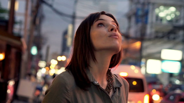 Young, Amazed Woman Looking Around City And Admire View At Night
