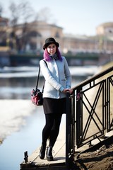 Stylish, young and beautiful girl with color hair poses on streets of St. Petersburg