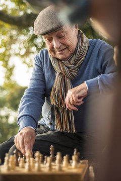 Senior man and grandson playing chess