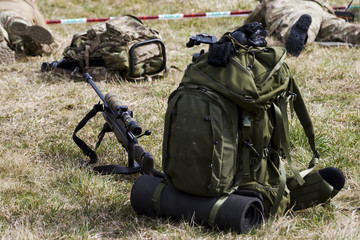 Military sniper aims at a target