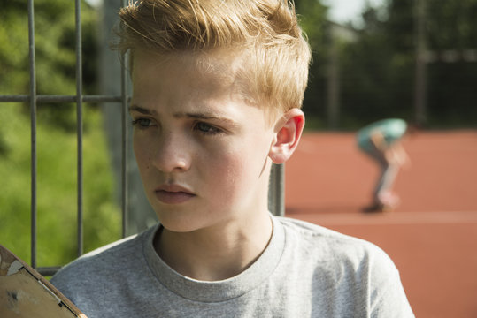 Portrait of serious teenage boy outdoors