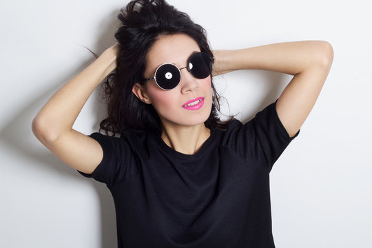 Portrait of beautiful sexy fashion model in round sunglasses