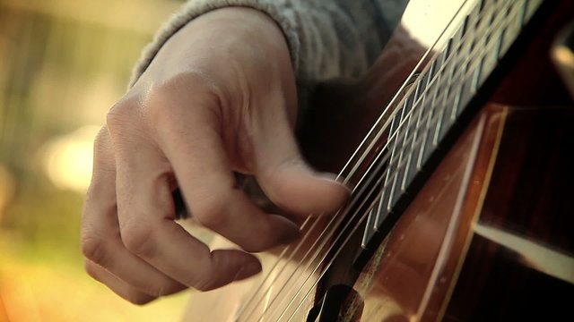 the arpeggio with fingers on a classical acoustic guitar

