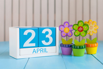 April 23rd. World Book Day. Image of april 23 wooden color calendar on white background with flowers. Spring day, empty space for text