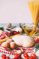 Pasta spaghetti, vegetables and spices, on wooden table.