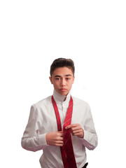 teenage boy tying a tie