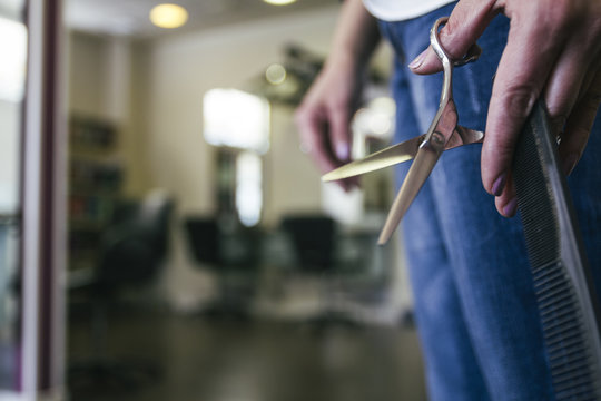 Hairdresser with scissors and comb in her hand