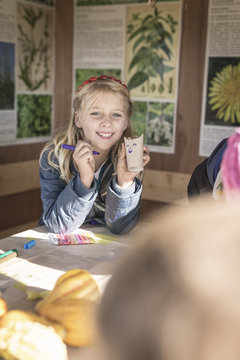 Girl tinkering paper bats
