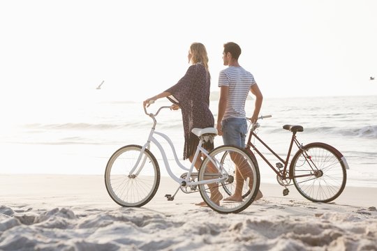 Cute couple walking next to bicycles