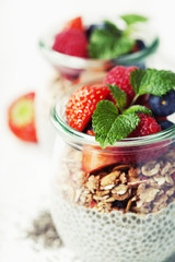 Chia seeds vanilla pudding and berries on wooden rustic backgrou