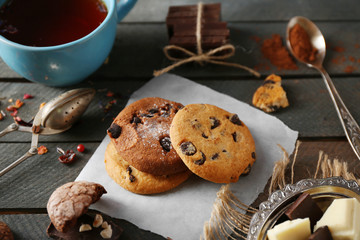 Chocolate chip cookies and a cup of tea on wooden background