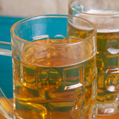 potato chips and two mugs of beer on the table