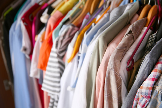 Clothes neatly hanging in the closet, close up