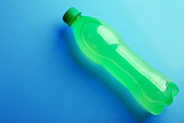 Bottle of soft drink on the blue background, top view