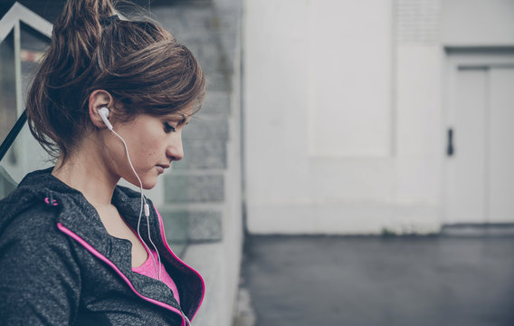 Portrait Of Mid Adult Sportive Woman With Ear Phones