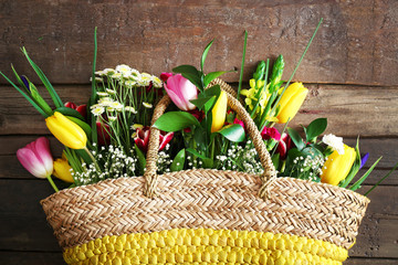 Bouquet of fresh flowers in a wicker basket